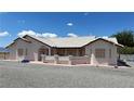 Low angle view of a single-story home with desert landscaping and light stucco at 2650 Sagebrush Ave, Pahrump, NV 89048