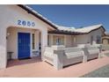 Close up of a front porch showcasing a blue steel door and concrete bench at 2650 Sagebrush Ave, Pahrump, NV 89048