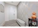 Inviting foyer with elegant decor and patterned accent wall, leading to the rest of the home at 3144 Tronzano Ave, Henderson, NV 89044