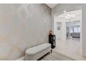 Elegant foyer featuring a patterned accent wall, bench seating, and views into the home at 3144 Tronzano Ave, Henderson, NV 89044