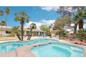 Gorgeous backyard pool with spa and beautiful landscaping that complements the home's exterior at 3155 Duneville St, Las Vegas, NV 89146