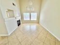Bright living room featuring tile flooring, a fireplace, and large windows for natural light at 3919 Lilac Haze St, Las Vegas, NV 89147