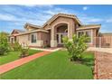 Well-maintained home with vibrant green lawn, complemented by mature landscaping at 4537 Colonial Canyon St, North Las Vegas, NV 89031
