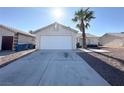 A one-story home with a large garage door and desert landscaping in the front yard at 4651 Wild Oak Way, North Las Vegas, NV 89031