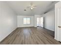 An open floor plan with new floors, a ceiling fan, and a large window at 4651 Wild Oak Way, North Las Vegas, NV 89031