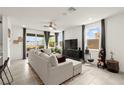 Bright living room with large windows, neutral decor, and comfortable seating area at 5530 Hill Spire St, Las Vegas, NV 89166