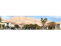 A quiet street view showcasing homes and majestic mountains under a bright sky at 6030 Halehaven Dr, Las Vegas, NV 89110