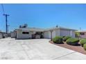 Single story home featuring a spacious driveway with desert landscaping at 6205 Parsifal Pl, Las Vegas, NV 89107