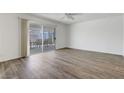 Bright living room featuring wood-look flooring and a sliding glass door at 6205 Parsifal Pl, Las Vegas, NV 89107
