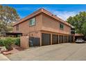 View of the home's exterior features multiple garages with an upper balcony at 6641 Silverstream Ave # C, Las Vegas, NV 89107