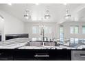 Modern kitchen island featuring a stainless steel sink, stylish pendant lights, and open layout concept at 724 Step Beach St, Las Vegas, NV 89138