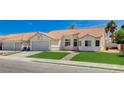 Charming single-story home with a well-maintained front lawn, desert landscaping, and a two-car garage at 7927 W Oquendo Rd, Las Vegas, NV 89113