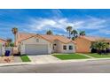 Charming single-story home with a well-maintained front lawn, desert landscaping, and a two-car garage at 7927 W Oquendo Rd, Las Vegas, NV 89113