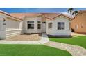Charming single-story home with a well-maintained front lawn, desert landscaping, and a two-car garage at 7927 W Oquendo Rd, Las Vegas, NV 89113
