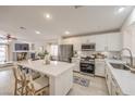 Bright kitchen with white cabinets, stainless steel appliances, and a large island with seating at 8136 Shady Glen Ave, Las Vegas, NV 89131