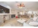 Inviting living room with a stone fireplace, ceiling fan, and an open floor plan at 8136 Shady Glen Ave, Las Vegas, NV 89131
