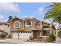 Beautiful two-story home with a tile roof, desert landscaping, and a two-car garage at 8216 Brittany Harbor Dr, Las Vegas, NV 89128