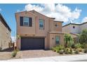 Charming two-story home with desert landscaping, a brick driveway, and attached two-car garage at 8724 Scalpay St, Las Vegas, NV 89166