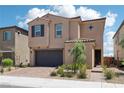 Charming two-story home with desert landscaping, a brick driveway, and attached two-car garage at 8724 Scalpay St, Las Vegas, NV 89166