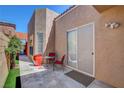 Inviting patio area with seating and a sliding door to the interior at 9215 Penn Station St, Las Vegas, NV 89123