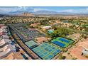 Aerial view of the community featuring a clubhouse, pool, tennis courts, and lush landscaping at 9409 January Dr, Las Vegas, NV 89134