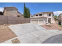 Two-story home featuring a three-car garage and a low-maintenance desert-landscaped yard at 9516 Belgate Ct, Las Vegas, NV 89129