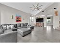 Spacious living room with vaulted ceilings, tile floors, a large sectional sofa, and an entertainment center at 9705 Cameo Rose Ln, Las Vegas, NV 89134