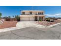 Two story home featuring a two-car garage, desert landscaping, and a charming white picket fence at 10290 Marion Morrison Ct, Las Vegas, NV 89183