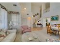 Spacious living room showcasing high ceilings, an open staircase, tile floors, and a seamless transition at 10290 Marion Morrison Ct, Las Vegas, NV 89183