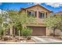 Two-story home featuring a well-maintained lawn, landscaping, and a two car garage at 10294 Running Falls St, Las Vegas, NV 89178