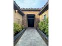 Charming stone walkway leads to the elegant double door entrance with stone surround at 11318 San Arezzo Pl, Las Vegas, NV 89141