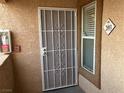 Secured front entrance features a decorative security screen door and building address at 1150 N Buffalo Dr # 2093, Las Vegas, NV 89128