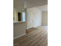 Open-concept living area with wood-look floors and a seamless transition to tile at 1150 N Buffalo Dr # 2093, Las Vegas, NV 89128