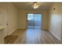 Bright living room with wood-look flooring and sliding glass doors to outdoor space at 1150 N Buffalo Dr # 2093, Las Vegas, NV 89128