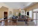 Second-story view of a living room with a fireplace and seamless access to other living areas at 11698 Firesteed Pl, Las Vegas, NV 89141