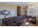 Open-concept living room featuring a large sectional sofa, high ceilings, and elegant decor at 11698 Firesteed Pl, Las Vegas, NV 89141