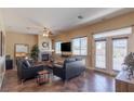 Cozy living room with a fireplace, neutral color palette, and access to the outdoor space at 11698 Firesteed Pl, Las Vegas, NV 89141