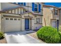 Close up of this beautiful home exterior with a two-car garage and manicured yard at 11919 Jersey Lilly St, Las Vegas, NV 89183