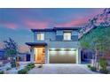 Charming home front view with a brick driveway, tidy landscaping, and an inviting entrance at twilight at 12341 Ferry Glide Ave, Las Vegas, NV 89138