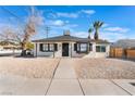 Charming single story home with a gravel yard and palm trees in the front at 1401 E Clark Ave, Las Vegas, NV 89101