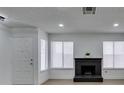 Inviting living room with modern black brick fireplace, bright natural light, and new floors at 1744 La Cruz Dr, Henderson, NV 89014