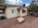 A low maintenance backyard with desert landscaping, accented by a mature shade tree at 1881 W Alexander Rd # 1035, North Las Vegas, NV 89032