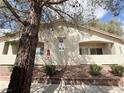 A two-story building with open air hallways and mature landscaping at 1881 W Alexander Rd # 1035, North Las Vegas, NV 89032