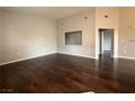 A spacious living room with hardwood floors and neutral paint, perfect for entertaining at 1881 W Alexander Rd # 1035, North Las Vegas, NV 89032