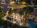 An aerial night view of the backyard featuring a beautiful pool, spa and desert landscaping at 2024 Spruce Brook Dr, Henderson, NV 89074