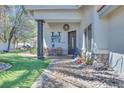 Inviting covered front porch with a seating area and well manicured landscaping at 217 Windsong Dr, Henderson, NV 89074