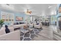 Bright, open-concept living room with fireplace and gray accent rug at 2268 Alanhurst Dr, Henderson, NV 89052