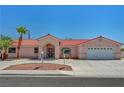 Charming single-story home featuring a red tile roof, desert landscaping, and an attached two-car garage at 2398 S Lamont St, Las Vegas, NV 89104