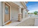 Inviting front porch with brick pavers, stone-clad columns, and a decorative front door with glass accents at 2486 Dragon Fire Ln, Henderson, NV 89052