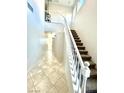 Foyer and staircase featuring neutral colors, tile flooring and natural light at 2749 Invermark St, Henderson, NV 89044